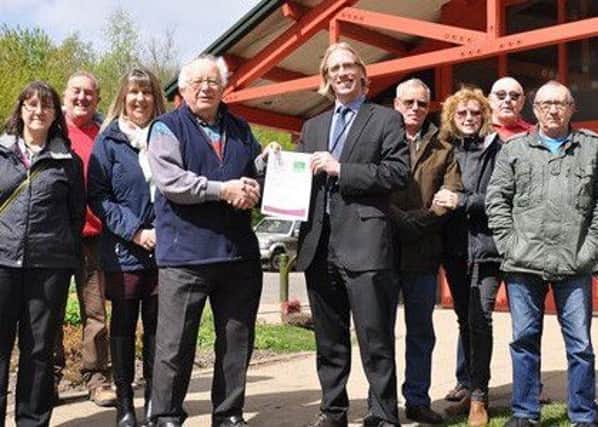 Staff at Brierley Forest Park and Ashfield District Council receive the accreditation from a Natural England representative.