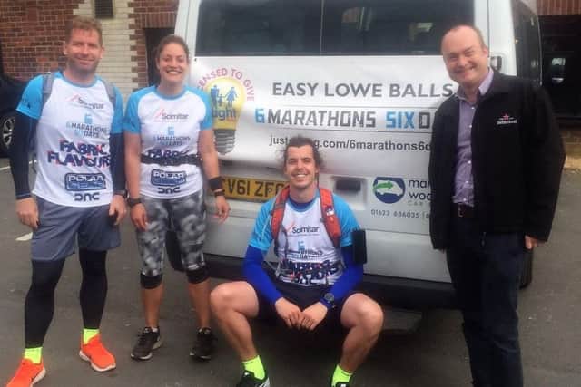 Ben Lowe (centre) with friends Jason and Katie, and his dad Martin, after their marathons.