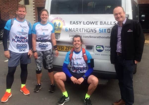 Ben Lowe (centre) with friends Jason and Katie, and his dad Martin, after their marathons.