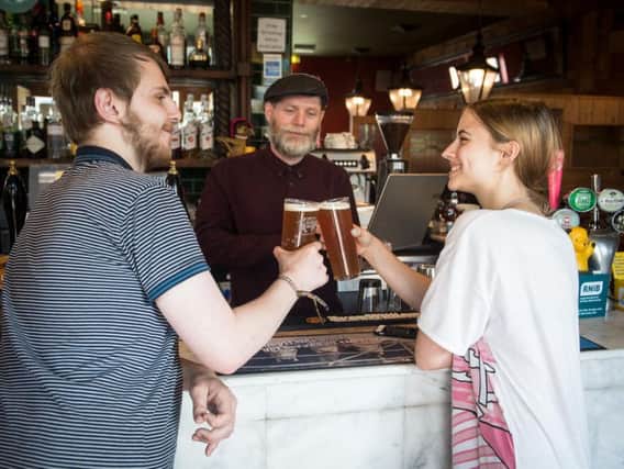 Joby Andrews talks to a young voter during the launch of the Vote This Year Get Free Beer campaign launch. Photo - SWNS