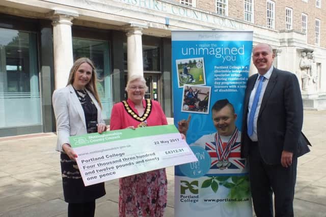 The cheque for £4,312.91 is presented by Coun Yvonne Woodhead (centre) to Mark Dale and Tracey Horton, of Portland College.