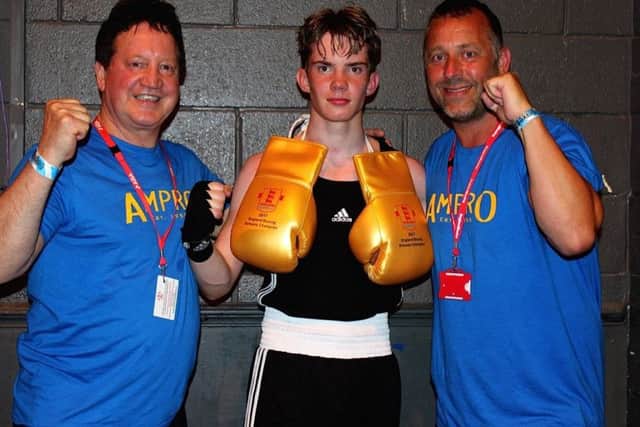 National champion Marcus Ellis, flanked by coaches Harry Watson (left) and Mark Curtis.