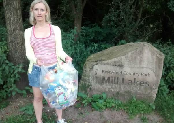 Georgina Harris shows off the rubbish she has collected on her weekly walk through Mill Lakes park.