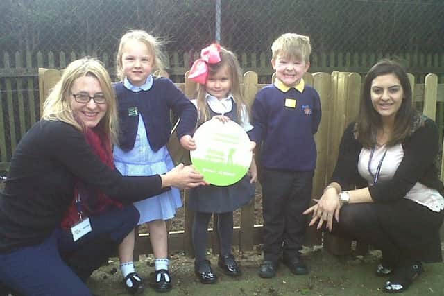 The county councils Lydia Powles hands a plaque to Asquith youngsters and teaching assistant, Thespo Yournimou.