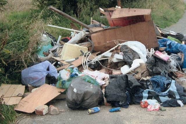 An example of the kind of fly-tipped waste by a roadside that councils have to clear up.