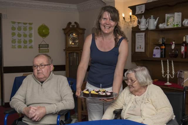 Cupcake event at Mansfield Manor Care Home, raising money for Alzheimers awareness day, tempting residents David Bradley and Gladys Cooper with some delicious cakes
