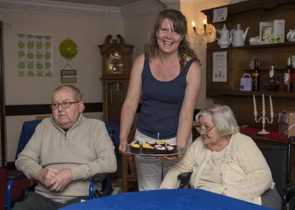 Cupcake event at Mansfield Manor Care Home, raising money for Alzheimers awareness day, tempting residents David Bradley and Gladys Cooper with some delicious cakes