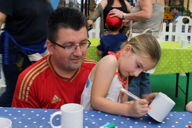 Erin Chamberlain decorating a mug for her father Shaun.