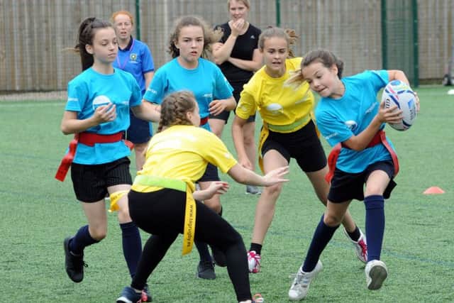 Girls from Quarrydale Academy in Sutton get stuck into the year-seven tag rugby competition at the Games.