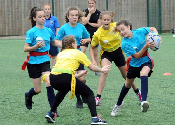 Girls from Quarrydale Academy in Sutton get stuck into the year-seven tag rugby competition at the Games.
