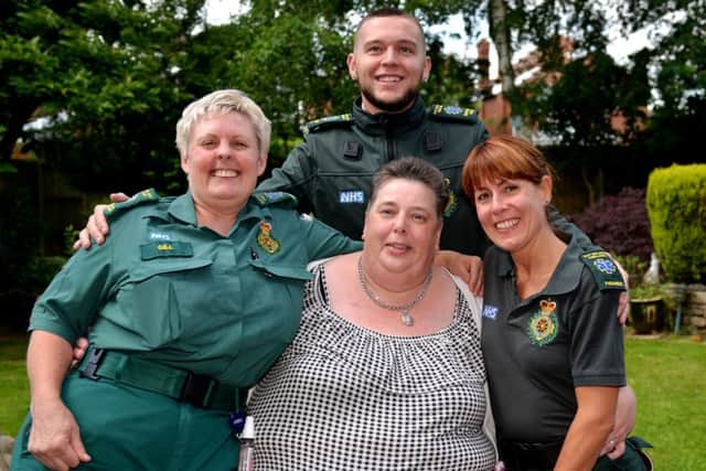 Cathy Cook is re-united with ambulance crew who saved her life when she developed severe pneumonia. Cathy is pictured with Gill Caldwell, Kyle Thacker and Rebecca Ireland