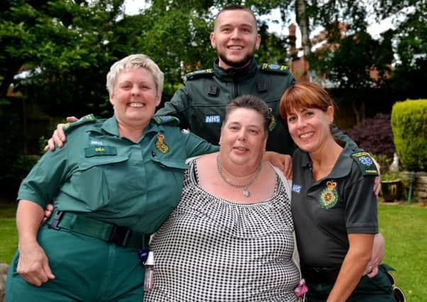 Cathy Cook is re-united with ambulance crew who saved her life when she developed severe pneumonia. Cathy is pictured with Gill Caldwell, Kyle Thacker and Rebecca Ireland