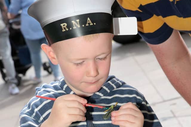 Harley Goodman has a go at painting toy soldiers at the Armed Forces Day event in Mansfield, United Kingdom, 25th June 2017. Photo by Glenn Ashley.