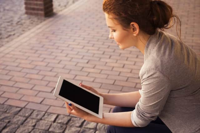Woman using tablet. Photo by Pixabay.