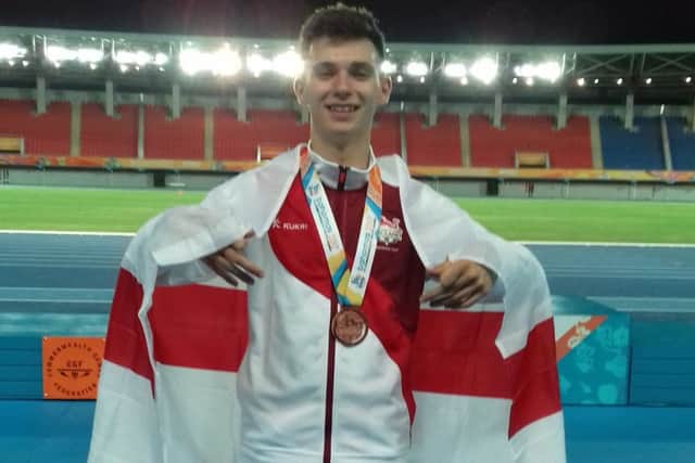 A jubilant Luke Duffy celebrates with the bronze medal he won at the Commonwealth Youth Games.