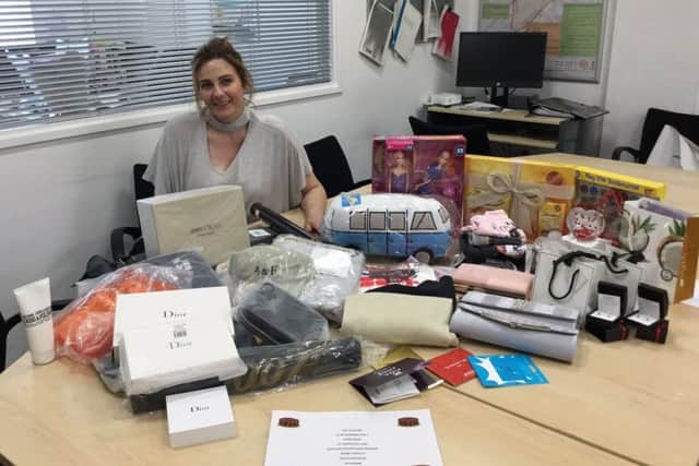 Grateful mum Wendy Willcock surrounded by items donated by retailers at Four Seasons Shopping Centre for the charity auction.