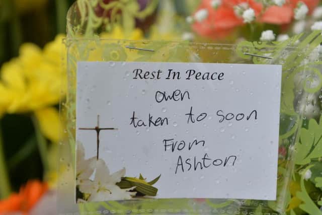 Tributes to Owen have been left at the scene. Photo - SWNS