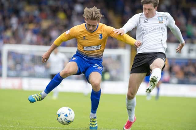 Mansfield's Danny Rose holds off a challenge.