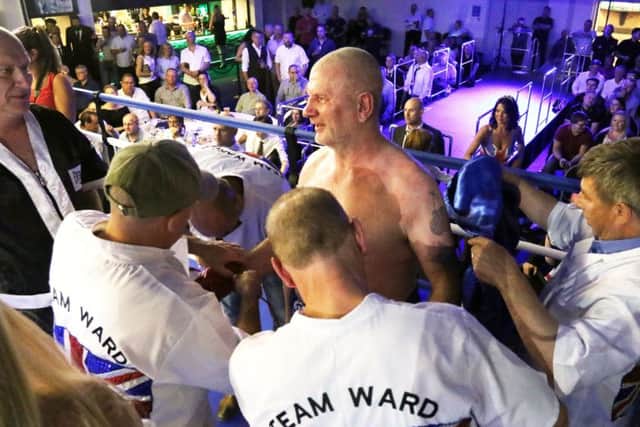 Team Ward surround Steve Ward making sure he is OK after being stopped by Siddons in the 7th round.