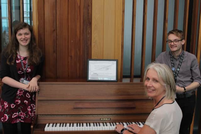Chief nurse Suzanne Banks on the piano, watched by hospital colleagues, Eleanor Shaw, from the urology team, and Ashley Pridmore, of the microbiology team.