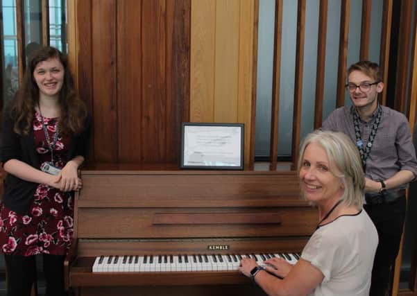 Chief nurse Suzanne Banks on the piano, watched by hospital colleagues, Eleanor Shaw, from the urology team, and Ashley Pridmore, of the microbiology team.