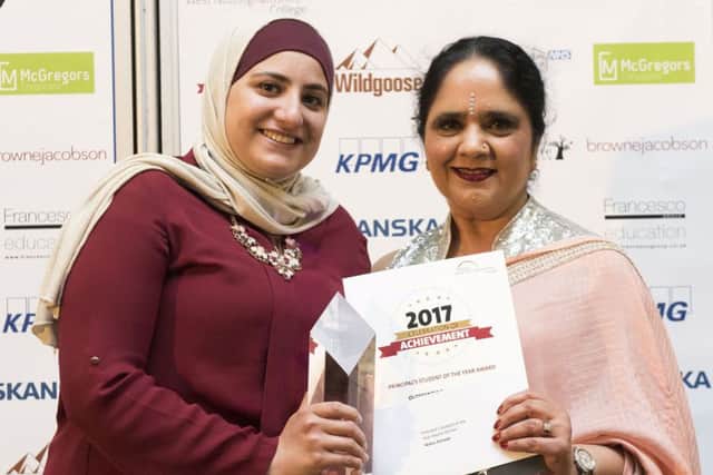 Refugee Maha Alchayb receives her award from  Dame Asha Khemka. (PHOTO BY: Tracey Whitefoot)