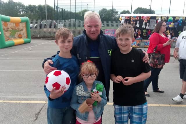 Alex Brown, 11, Amelia Lamb, 6 and Jayden Richards, 12, with manager, Steve Evans