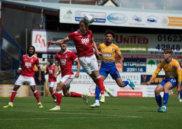 Mansfield Town vs Nottingham Forest -Joe Worrall heads the ball away - Pic By James Williamson