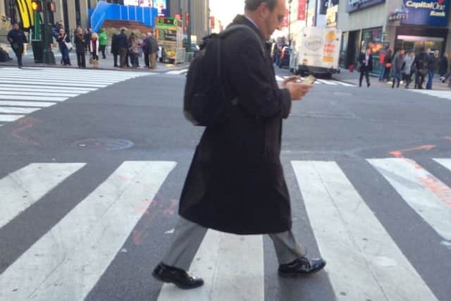 Pedestrians have been banned from looking at their mobile phones while crossing the street in Honolulu - should similar mesaures be used in England.