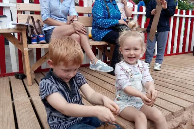 Warren Hawkesley 5 and Paige Hawkesley 3 playing in the sand at Life's a Beach.