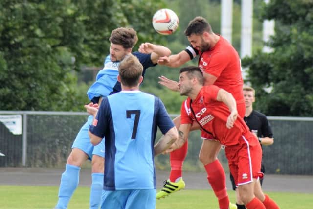 Its a case of heads up in this aerial clash during AFC Mansfields victory over Bottesford Town in their first match of the season. (PHOTO BY: Peter Craggs)