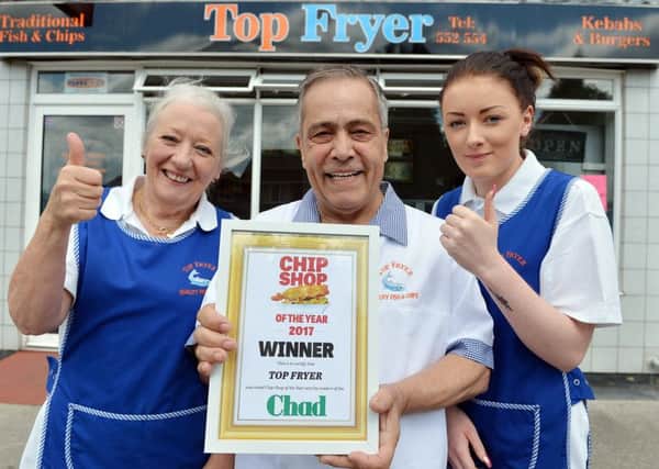 Top Fryer in Sutton has been crowned winner of the Chad's chippy of the year contest. Pictured are owners Ann and Teyfik Marasli and, right, assistant  Abbie Wilson.