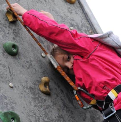 Summer Festival event at Titchfield Park.Luciemae Gundel, 6, dares to look down from the climbing wall.