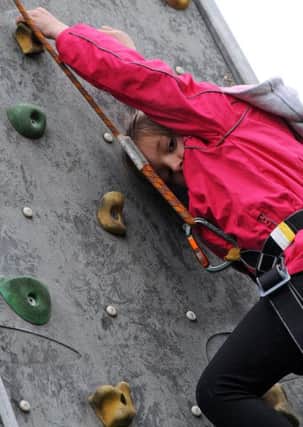 Summer Festival event at Titchfield Park.
Luciemae Gundel, 6, dares to look down from the climbing wall.