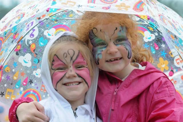 Summer Festival event at Titchfield Park.  Rebecca Cox and Katie Cutt, both 6, brighten up a cloudy day with their fabulous face paint designs.
