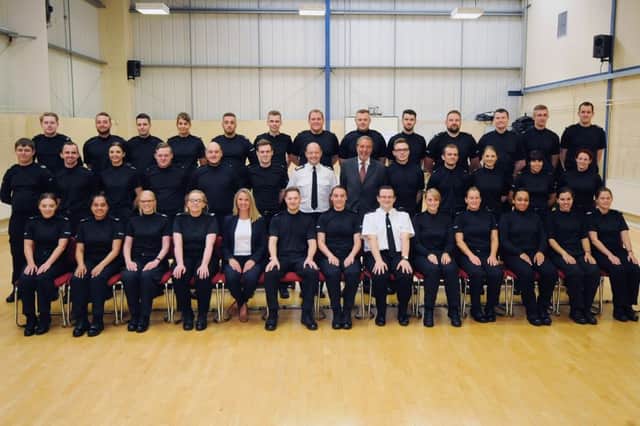 New Nottingham Police recruits line up with the Chief Constable, Craig Guildford, and Nottinghamshire's Police and Crime Commissioner Paddy Tipping and constables, Alastair Roper and Lisa Davies.