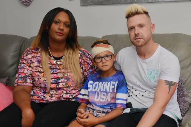 Romeo Smith, nine, was injured by bullies while playing near his home. Romeo is pictured with Mum Natasha and Dad Craig