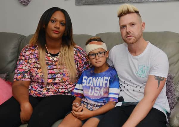 Romeo Smith, nine, was injured by bullies while playing near his home. Romeo is pictured with Mum Natasha and Dad Craig
