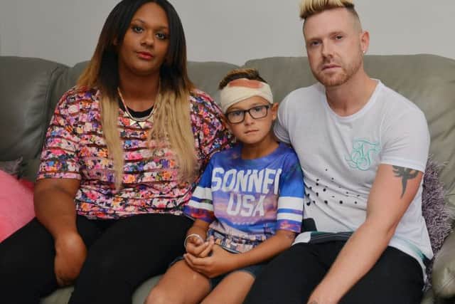 Romeo Smith, nine, was injured by bullies while playing near his home. Romeo is pictured with Mum Natasha and Dad Craig