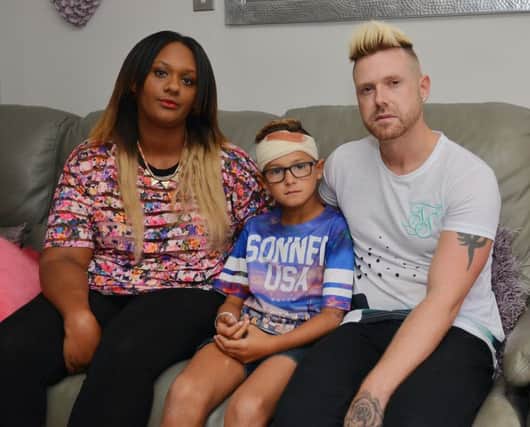 Romeo Smith, nine, was injured by bullies while playing near his home. Romeo is pictured with Mum Natasha and Dad Craig