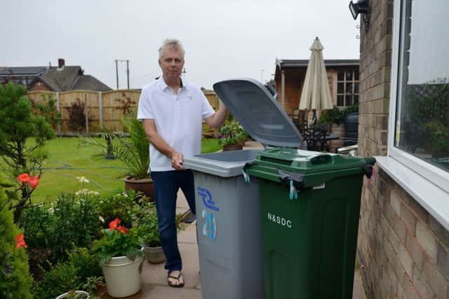 New smaller bins to be introduced by Newark and Sherwood Council are half the size of the original bins, pictured is Chris Drabble with his bins