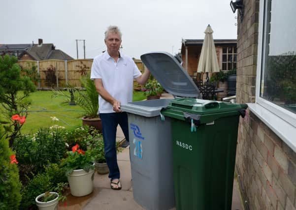 New smaller bins to be introduced by Newark and Sherwood Council are half the size of the original bins, pictured is Chris Drabble with his bins