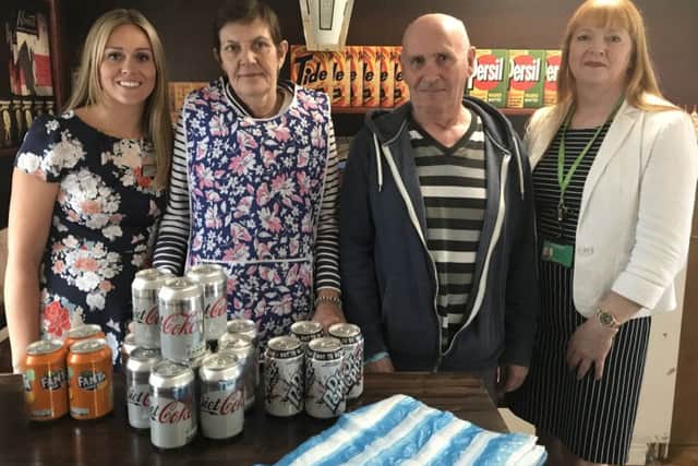 Hatzfeld Care Home Manager Jessica Poznanski with residents Julie Sekowski and David Health and Nottinghamshire County Council's Cherry Dunk behind the counter of the residents' shop in the home.