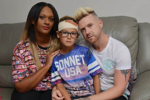Romeo Smith, nine, was injured by bullies while playing near his home. Romeo is pictured with Mum Natasha and Dad Craig