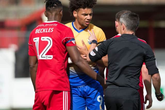 Accrington Stanley vs Mansfield - Referee Darren Bond has words with Lee Angol of Mansfield Town - Pic By James Williamson
