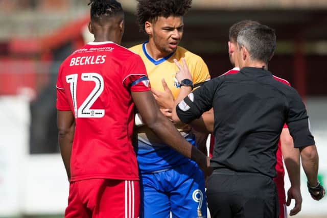 Accrington Stanley vs Mansfield - Referee Darren Bond has words with Lee Angol of Mansfield Town - Pic By James Williamson