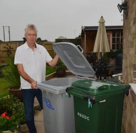 New smaller bins to be introduced by Newark and Sherwood Council are half the size of the original bins, pictured is Chris Drabble with his bins