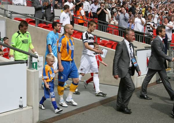 Duncan Russell leads out Mansfield Town in the FA Trophy 2011 final - Pic by: Richard Parkes