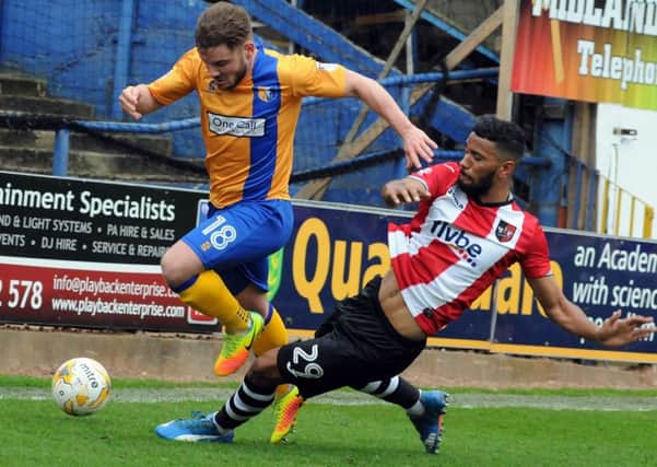 Mansfield Town v Exeter.
Alex MacDonald is taken out in the first half.