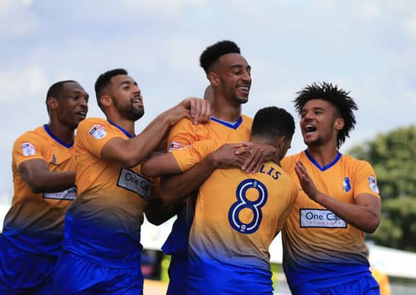 Rhys Bennett of Mansfield Town celebrates his goal with Mansfield team mates during the Sky Bet League 2 match between Mansfield Town and Luton Town at the One Call Stadium, Mansfield, England on 26 August 2017. Photo by Leila Coker.